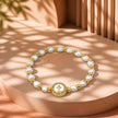 Pulsera perla dije nacar cruz
